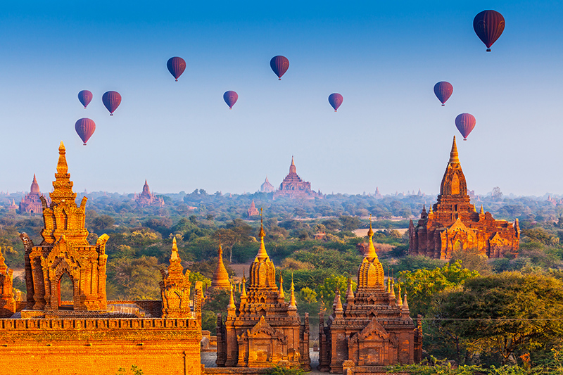 Hot air balloons rise high in the Burmese sky